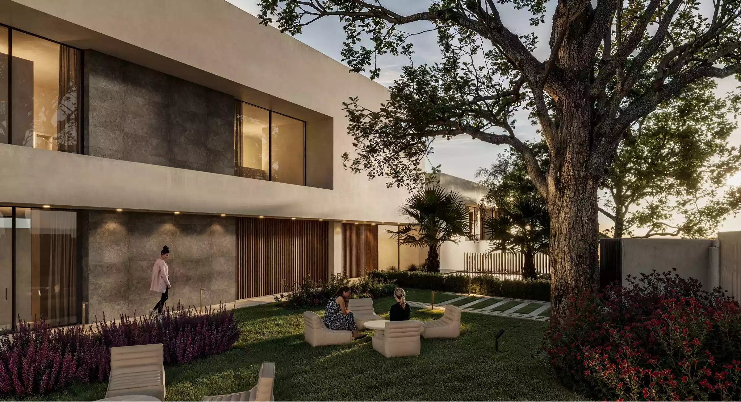 Jardín tranquilo con asientos modernos bajo un árbol, diseñado para la reflexión serena y la conexión durante la recuperación.