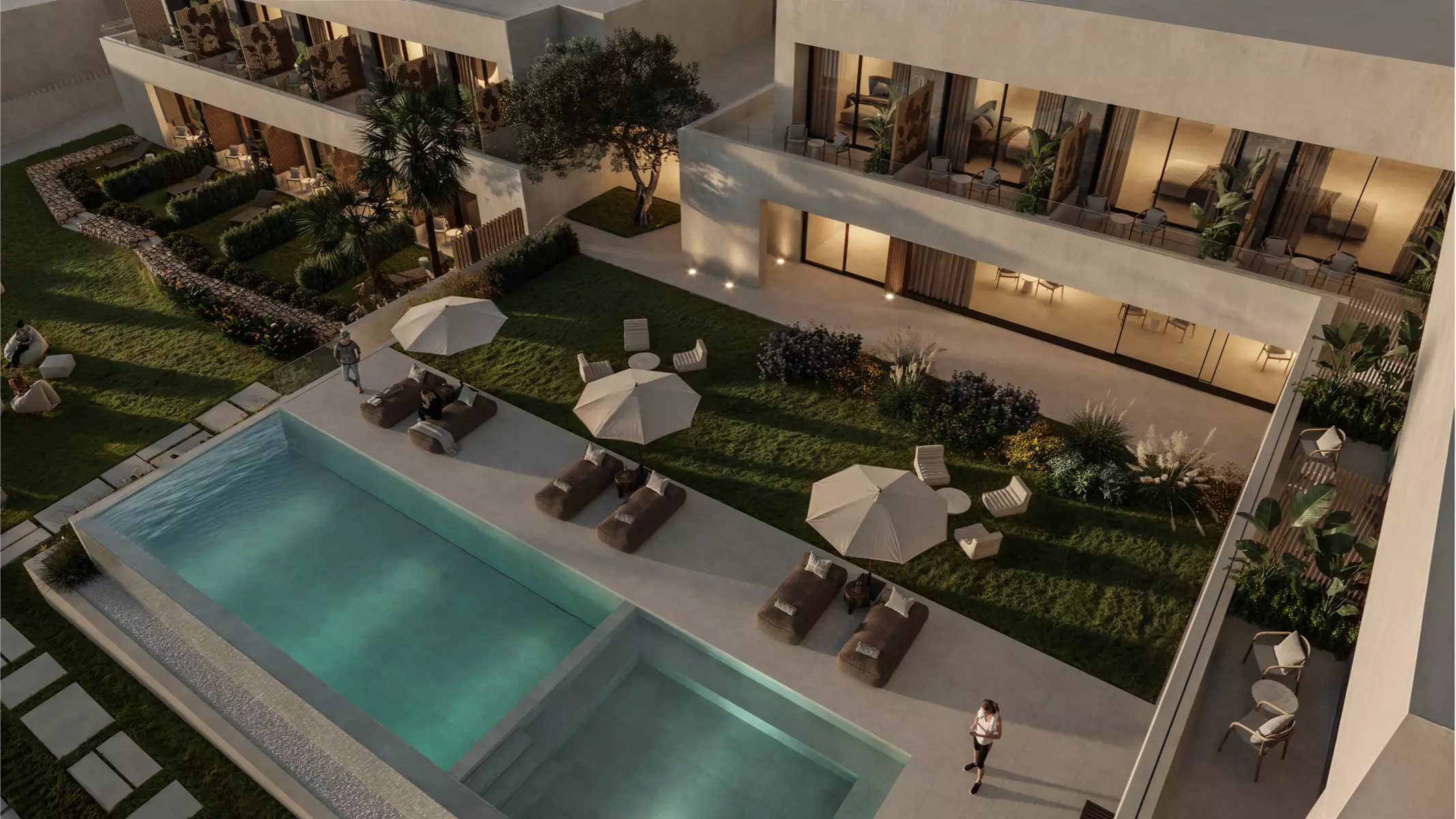 Vista aérea de la piscina y las zonas ajardinadas de Naghoi, con tumbonas, sombrillas y acceso directo a habitaciones privadas para nuestros pacientes.